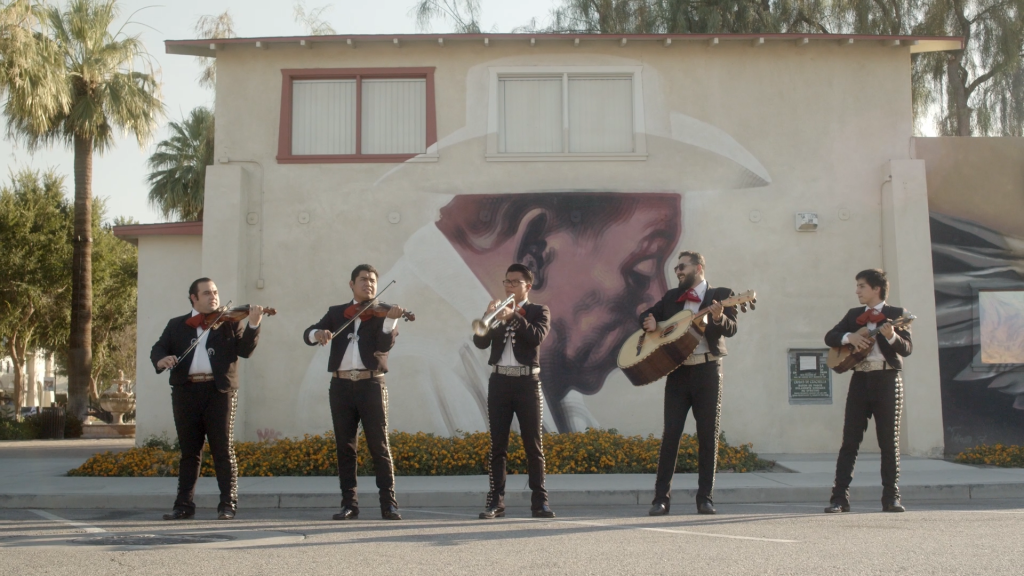 Mariachi band playing in front of Coachella Valley art